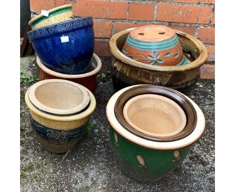 A quantity of glazed ceramic planters of various sizes 