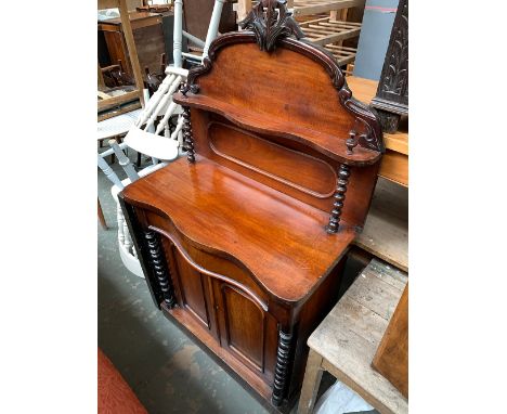 A late Victorian mahogany chiffonier, serpentine front with single drawer, cupboards below flanked by bobbin turned columns, 