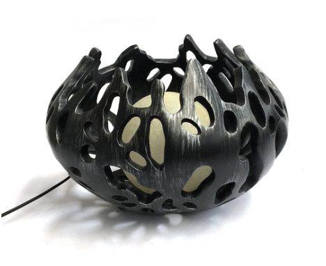 A pierced black resin table lamp with central orb shade, approx. 45cm wide 