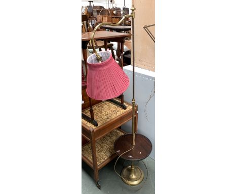 A floorstanding brass lamp, adjustable height, with turned dished shelf 