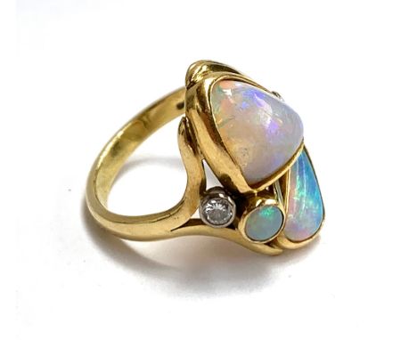 An 18ct yellow gold ring set with freeform opals, and two brilliant cut diamonds (approx. 0.11cts), approx. size O, 6.1g 