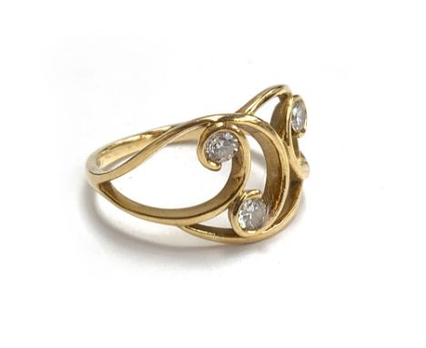 An 18ct gold Art Nouveau ring set with three brilliant cut diamonds, size P 1/2, 3.8g 