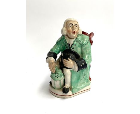 A 19th century Staffordshire Toby jug, modelled as George Whitfield the night watchman seated holding a lantern, 23cmH 