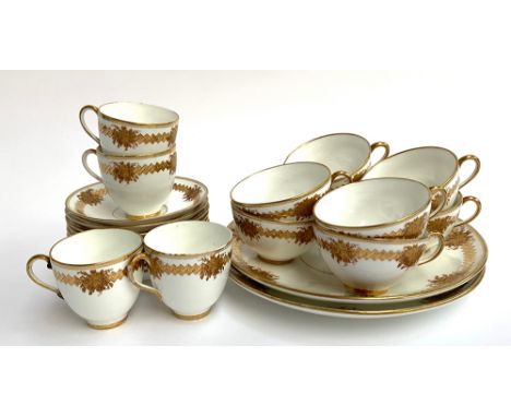 A part tea service heightened in gilt with floral decoration, comprising eight teacups, four coffee cups (one with staple rep