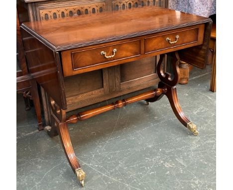 A mahogany sofa table, two drawers on swept legs, brass pad feet and casters, 91x54x75cmH 