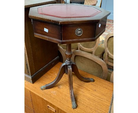 A small octagonal drum table, on four swept legs, 61cmH 