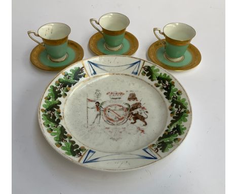 Three Royal Worcester green coffee cups heightened in gilt, reg no. 651926; together with an armorial plate, 22cmD 