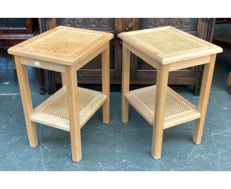 A pair of light oak occasional tables, with caned top and undershelf, one with glass inset top, 31x38x52 