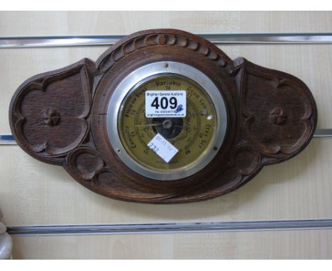 BAROMETER IN CARVED OAK CASE