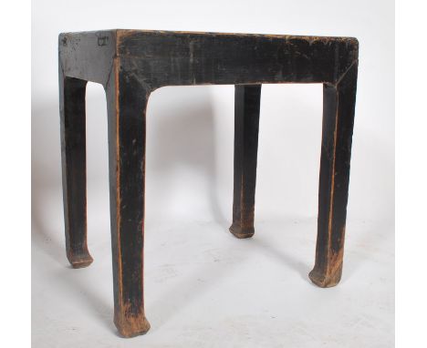 A believed early 20th century Chinese opium stool in elm wood having an ebonised painted and lacquered finish. The stool tabl