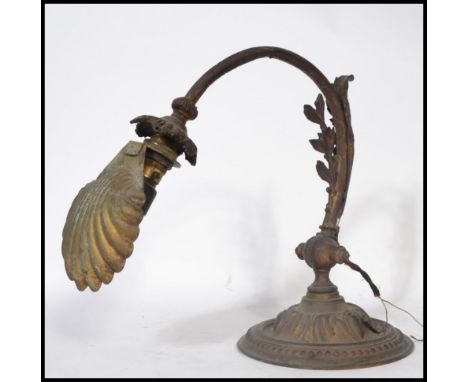 A 19th century Art Nouveau desk / wall light of cast metal construction. Raised on a beaded circular base with adjustable aca