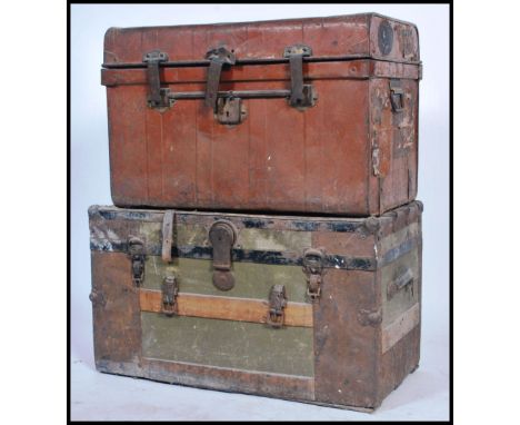 Two vintage early 20th century steamer trunks to include a canvas and wooden bound military trunk together with another of ti