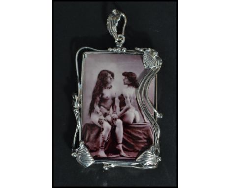 A large sterling silver panel necklace pendant having an inset erotic scene of two ladies. Weighs 24 grams.