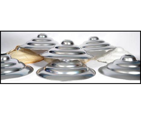 A set of eight vintage 20th century retro ' Space Age ' chrome ceiling pendant UFO type light shades of stepped conical form.