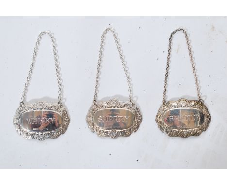 A.&nbsp; collection of 4 silver hallmarked Decanter labels to include Gin, Brandy, Sherry and Whisky, all with chains. Hallma