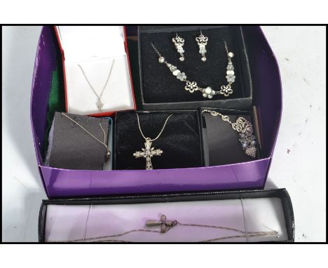 A group of vintage silver necklaces and pendants to include crucifix , flowers , white stone , heart etc. Please see images.