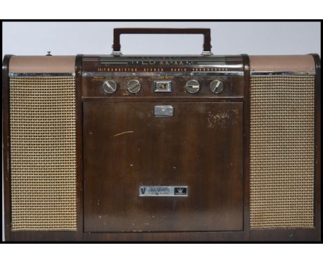 A vintage mid 20th century Crown V stereo 12 transistor stereo radio phonograph record player. Measures 49 cm high and 67 cm 