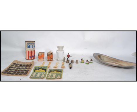A collection of vintage curios to include 19th century bone spoons, thimbles, needle case in the form of a deers leg, buttons