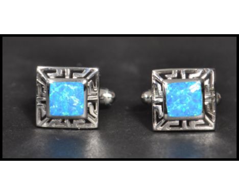 A pair of sterling silver and opallite panel cuff links of square form having pierced sides and T back. Weighs 8 grams.