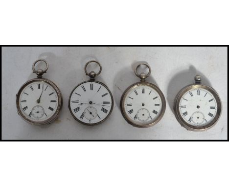 A group of four vintage early 20th century silver pocket watches all having white enamel faces with Roman Numeral chapter rin