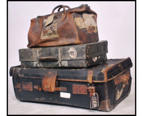 A collection of early 20th century luggage to include a large canvas and leather bound trunk,&nbsp; leather gladstone style b