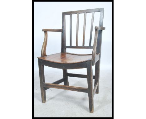 A 19th century Georgian country house beech and elm elbow / hall chair raised on squared leg supports united by stretchers wi