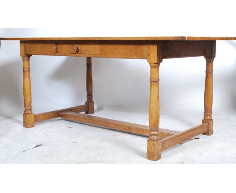 A large 20th century good quality country oak refectory dining table being raised on turned legs with peripheral stretchers. 