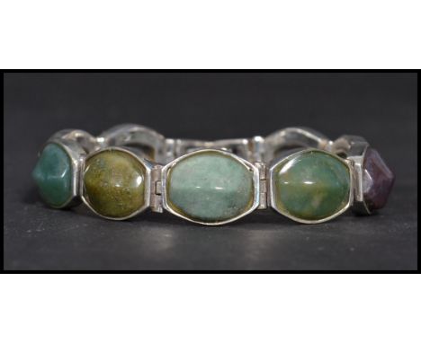 A sterling silver panel bracelet set with agates having a fold over clasp. Weighs 50 grams.