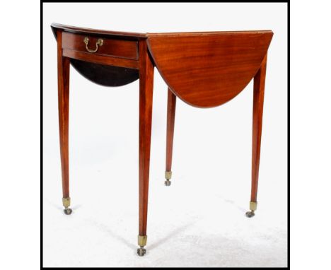 An early 20th century Edwardian mahogany occasional drop leaf table, raised on square tapering legs on brass castors having b