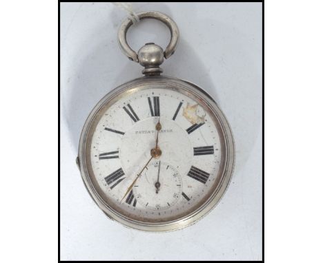 An early 20th century silver cased pocket watch part lever. The white enamel face with Roman numeral chapter ring , gilt face