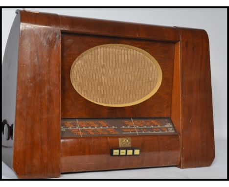 A vintage 20th century HMV His Masters Voice mahogany cased radio with oval grille dials and buttons to front. Model Number 8