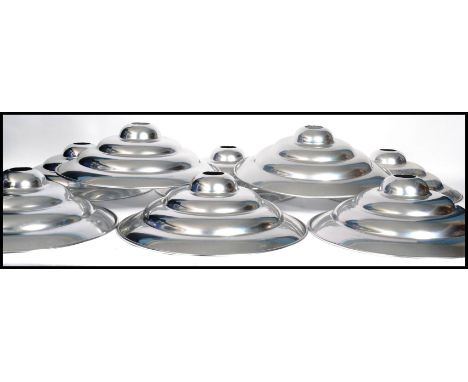 A set of eight vintage 20th century retro ' Space Age ' chrome ceiling pendant UFO type light shades of stepped conical form.