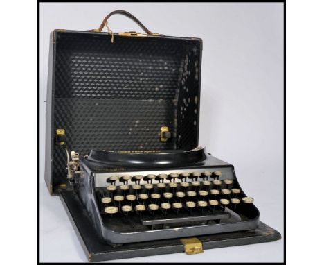 A vintage retro 20th century industrial portable typewriter by Remington. The Home Portable typewriter in original carry case