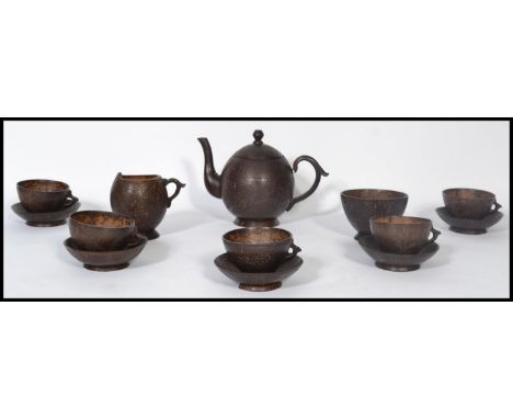 A believed early 20th century Asian antique coconut five piece tea set comprising of a teapot, sugar bowl. creamer and five c