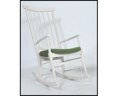 A vintage retro 1970's danish inspired ladder back rocking chair constructed from beech wood with a woolen moss green upholst