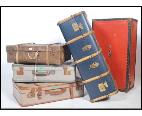 A collection of vintage 20th century steamer trunks and suitcases to include wooden bound steamer trunk. Five in total.&nbsp;