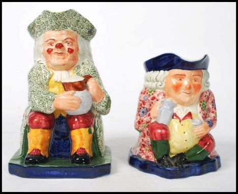 Two early 20th century Copeland Spode Toby jugs. One with floral jacket and one having a leaf design. Marks to base. Measures
