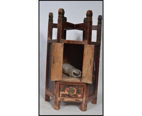 A late Qing dynasty Chinese hexagonal worktop washstand having a drawer to bottom and twin door cupboard revealing storage sp