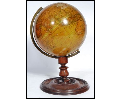 A 19th Century New Terrestrial Globe, published by H Collins of London, on a turned mahogany stand and circular base. 36cm ta