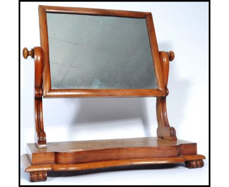 A 19th century&nbsp; Victorian walnut swing frame dressing table mirror, the serpentine fronted base with bun feet. H55cm x W