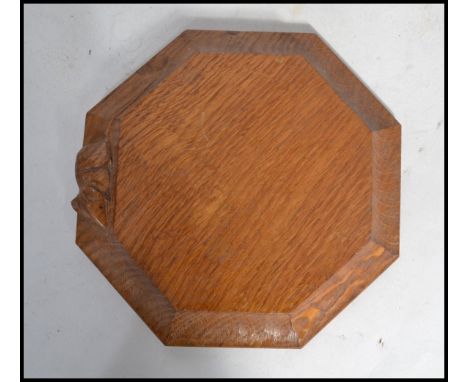 A Robert Thompson of Kilburn&nbsp; ' Mouseman ' octagonal cheese board with trademark mouse on the outside edge. Measures 19c