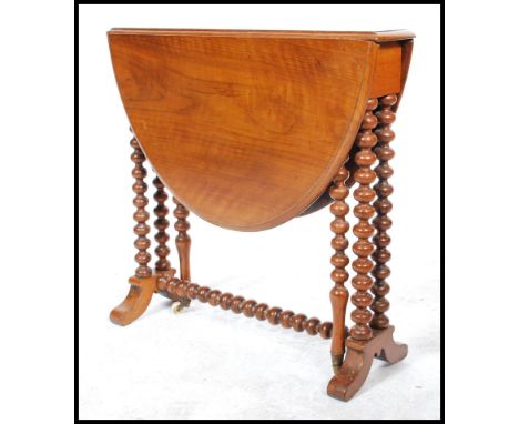 A 19th century Victorian walnut oval Sutherland table, moulded top, turned twin bobbin legs, ceramic casters.&nbsp;Measures 5