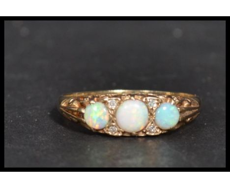 A hallmarked 9ct gold three stone opal dress ring.