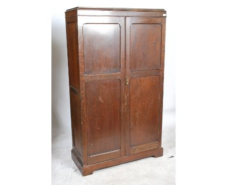 A 1930's oak Aw-Lyn double wardrobe compactum having oak full length qtr panel doors with haberdashery lined shelves set with