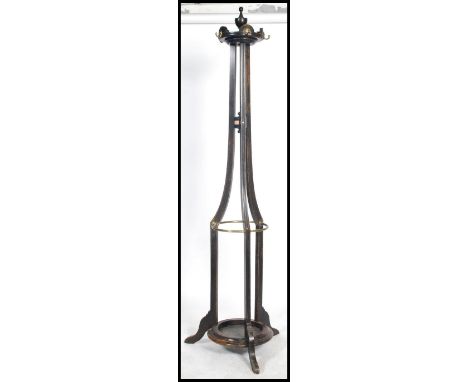 A Victorian oak tall cylindrical tapering stick stand / hallstand having peripheral stretchers and lower tray having finial c