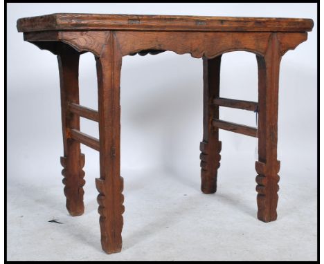 A mid Qing dynasty Chinese antique elm wood wine table from the Shanxi province having a double stretcher to sides and a carv