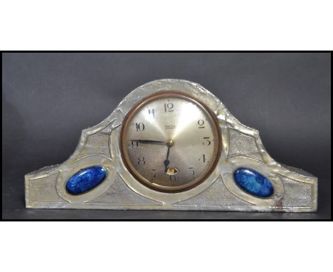 A Tudric pewter Art Nouveau mantle clock in the manner of&nbsp;Archibald Knox of Liberties. The clock having lapis lazuli / c
