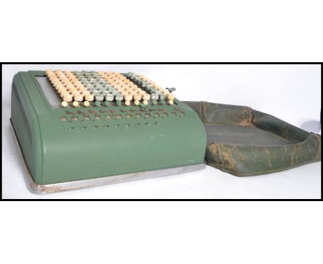 A vintage industrial Comptometer key-driven mechanical calculator, counting machine with original dust cover / jacket. Measur