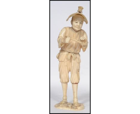 A 19th century Japanese Sectioned Ivory Okimono of a Merchant, Meiji period possibly of a musician playing a flute signed to 