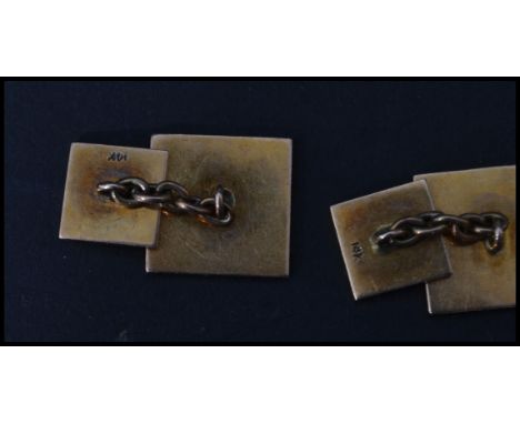 A pair of vintage early 20th century 14 carat gold cufflinks / cuffs of square form having an engine turned decoration. Stamp